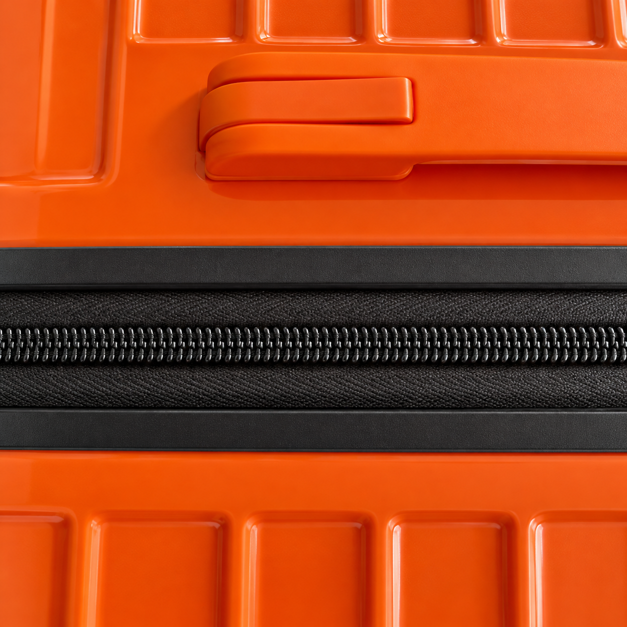 Close-up of orange luggage zipper track